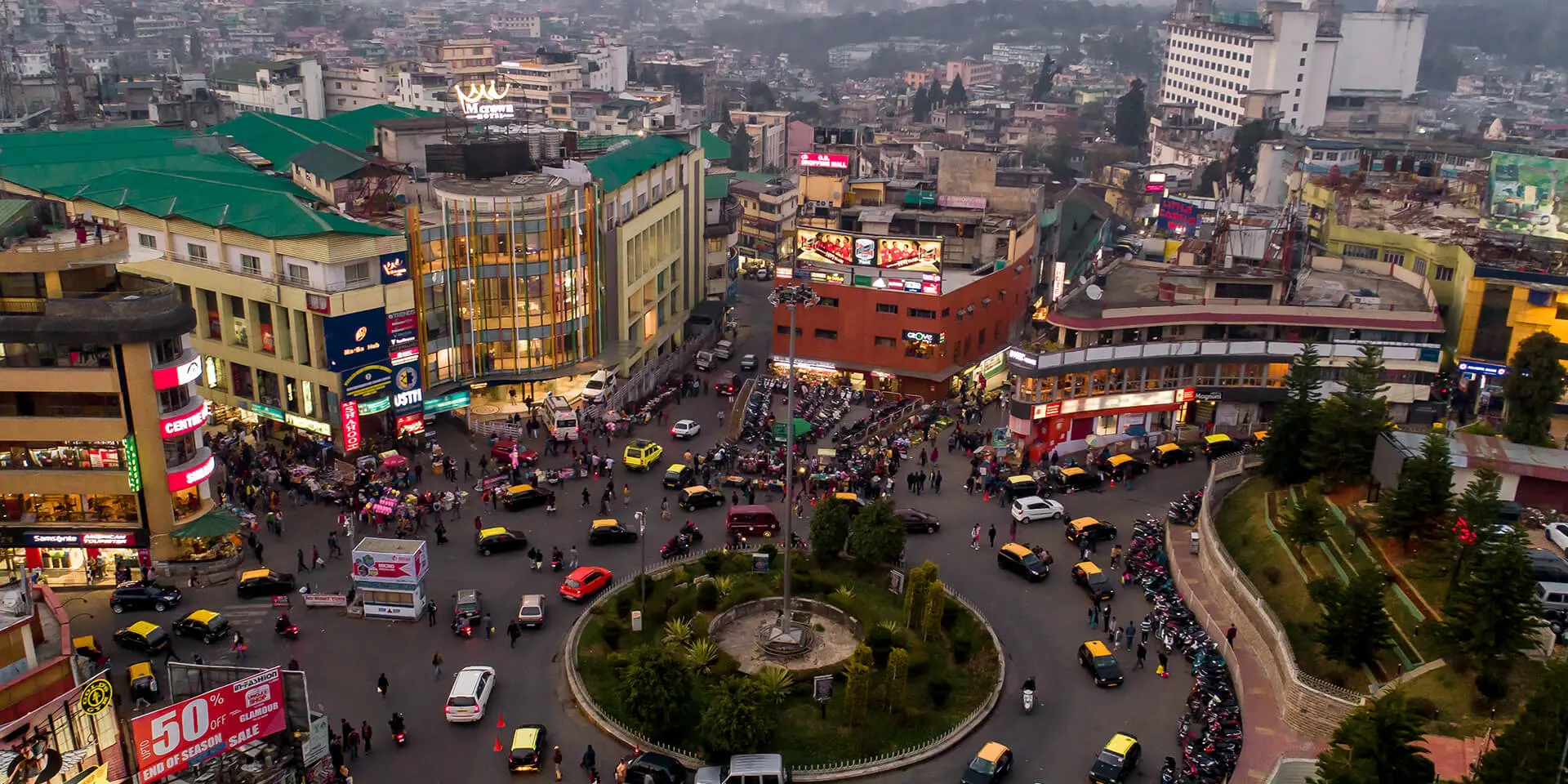 View of the main road at Police bazar in Shillong with shops, vehicles and people.